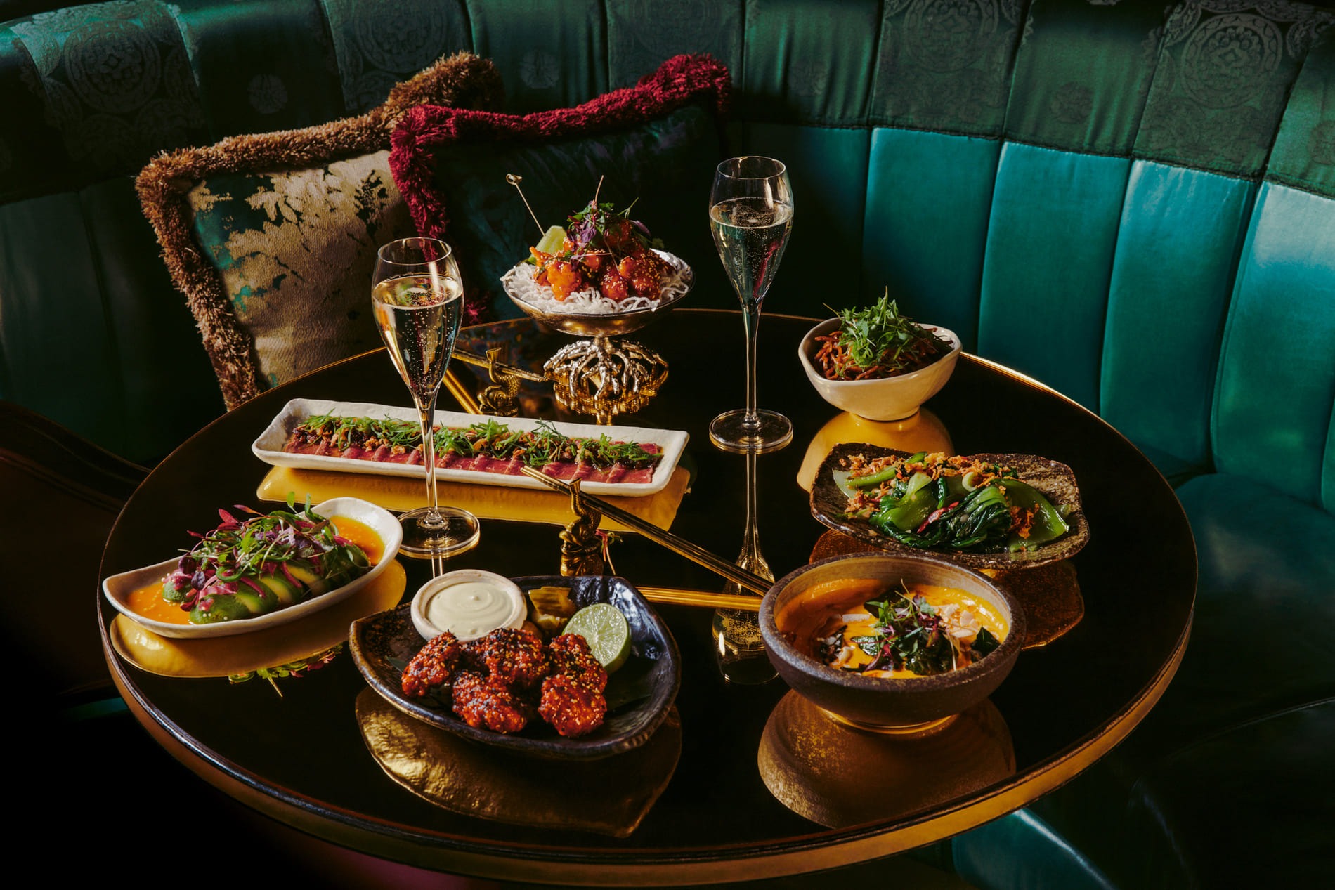 Sharing plates and two glasses of Champagne at The Ivy Asia Mayfair in London.
